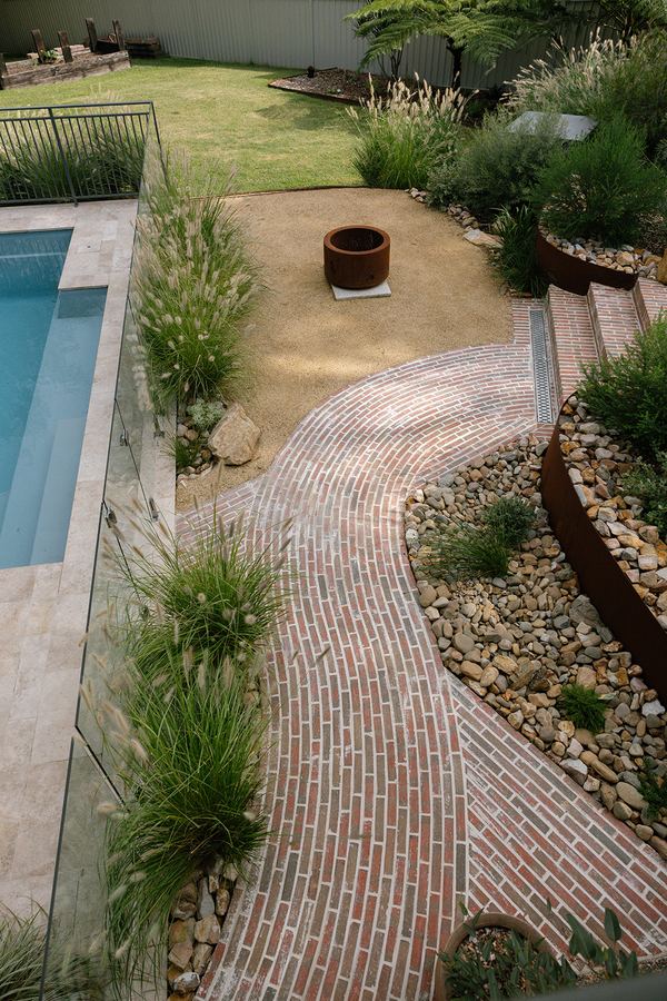 Established brick garden pathway maintained by Greau — regenerative garden care, Illawarra NSW