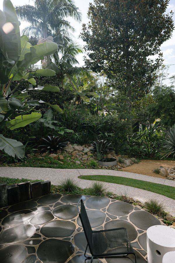 Established stone patio surrounded by lush plantings — mature garden care Thirroul